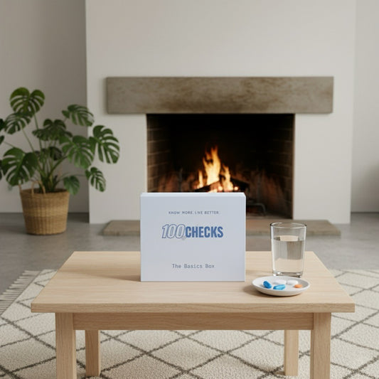 Supplement Vitamin Box labeled '100Checks' on a coffee table in front of a fireplace